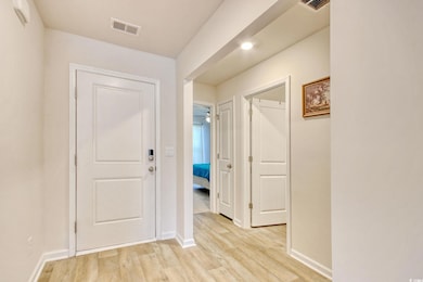 Interior space featuring visible vents, baseboards