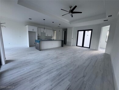Kitchen featuring white cabinets, ceiling fan, a r