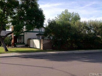 Side view of house, featuring the fireplace, front