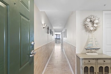 Corridor featuring wainscoting