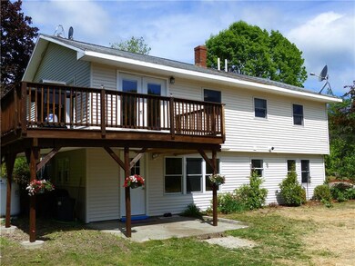 Back view of home with wraparound deck.