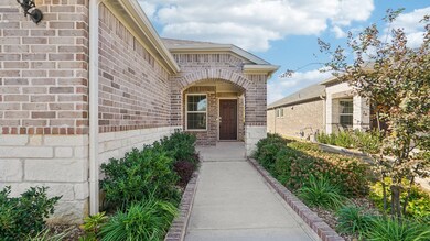 Entrance to property with brick siding and roof with shingles
