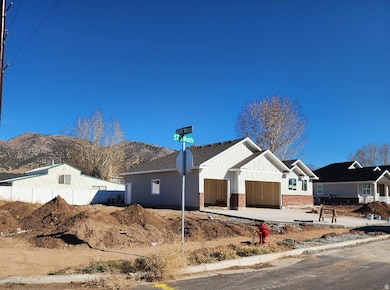 View of front of home with a garage, driveway, board and batten siding, brick siding, and a mountain view