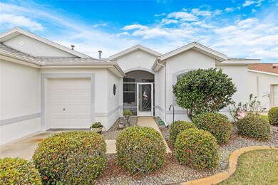 BEAUTIFUL ENTRYWAY WITH GOLF CART GARAGE AND SCREENED FRONT PORCH 