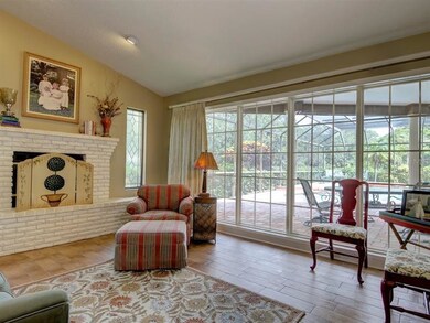 LIVING ROOM WITH FIREPLACE OVERLOOKING THE POOL AR