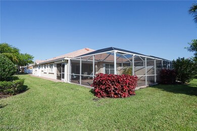 Rear view of house with glass enclosure, stucco si