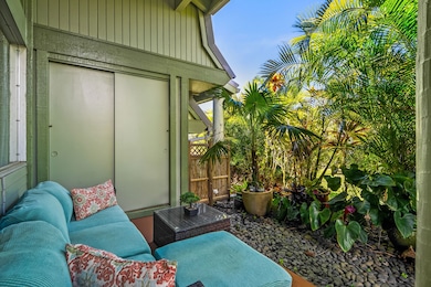 Lush and private covered outdoor lanai with a storage closet.