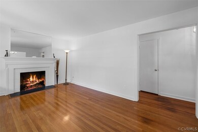 Living room featuring a brick fireplace and hardwood  floors.