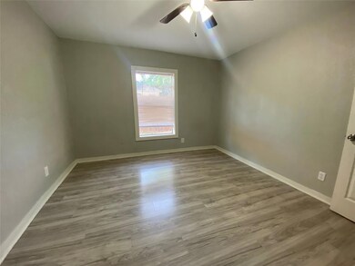 Spare room featuring hardwood / wood-style floors and ceiling fan
