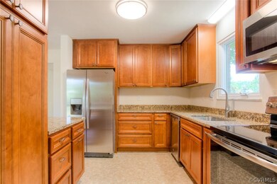 Kitchen with new granite counter tops and new cabinets and appliances.