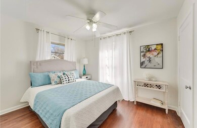 Bedroom with wood finished floors and a ceiling f