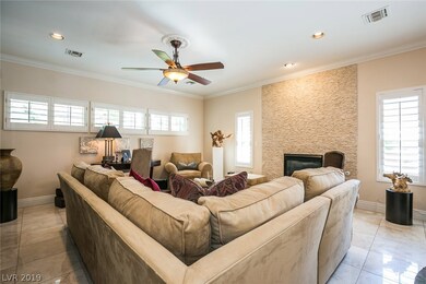 Family room with shutters throughout, floor to cei