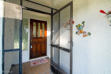 View of exterior entry featuring stucco siding