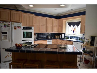 Kitchen. Tile counters & floors, wall ovens, islan