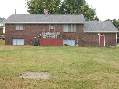 A view of the back of the home, deck off of the ki
