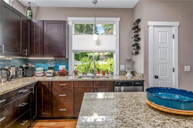 Tile backsplash sets the scene for this lovely kitchen with huge window over the sink