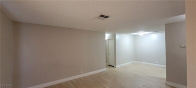 Spare room with light wood-style flooring, a textu