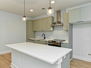 Kitchen with wall chimney exhaust hood, stainless