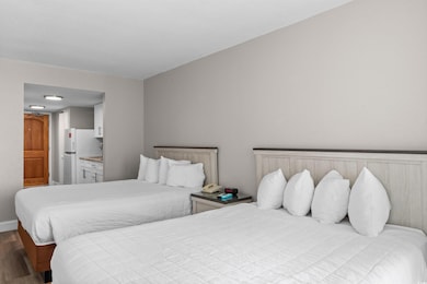 Bedroom featuring wood finished floors and ensuite bath