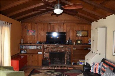 Family room with a beautiful brick fireplace, two 