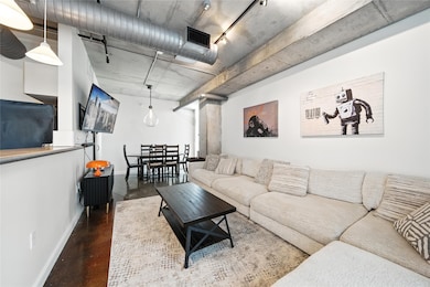 The cozy living room with a view of the dining room and access to the laundry and powder room