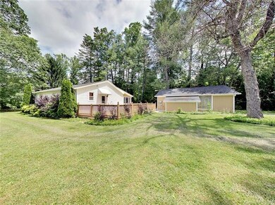 Rear of home with large deck. Nice level yard for 