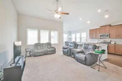 This is a spacious open-plan living area with ampl