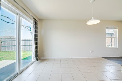 Empty room with tile patterned floors and baseboards