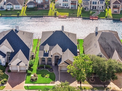 Aerial view of the front of the home with the lake