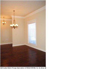 Gleaming wood floors decorate the open dining room