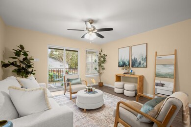 Living area featuring baseboards, a ceiling fan, 