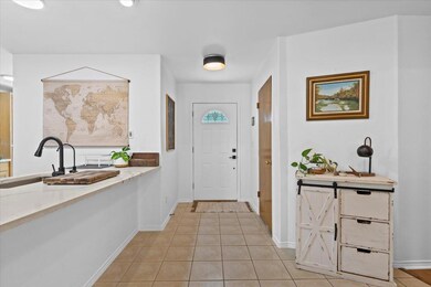 Foyer entrance with light tile patterned floors a