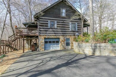 Stone surround garage opens to oversize space with work area