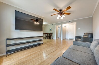 Living room with ceiling fan, light hardwood / wood-style floors, and crown molding