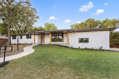 View of front of house featuring a front lawn and a porch