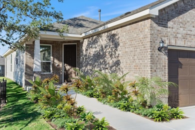 Entrance to property featuring brick siding, a ga