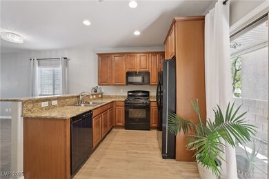 Kitchen featuring black appliances, a sink, a peni