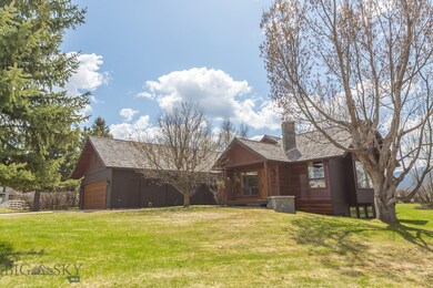 Front of house with stone planter and front porch