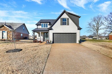View of front of house featuring central AC unit, a porch, and a garage