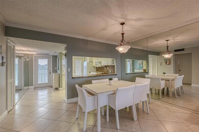 Dining room with open window into kitchen and larg