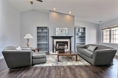 Gorgeous Newly painted Spacious Living room with Recessed can light to highlight the beautiful Gas Fireplace with Black Mantel and Ceramic hearth. New Beautiful Wood vinyl plank floors!