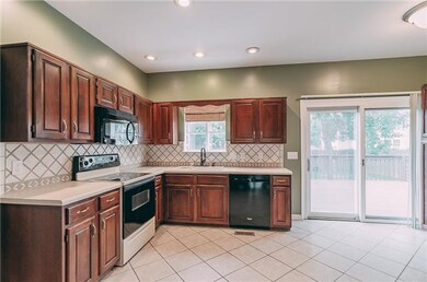 Spacious 15x16 kitchen with tiled flooring, tiled 
