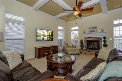 A wonderful Gathering Place ~ a lovely Family Room with coffered ceiling, stone gas log fireplace with hearth.