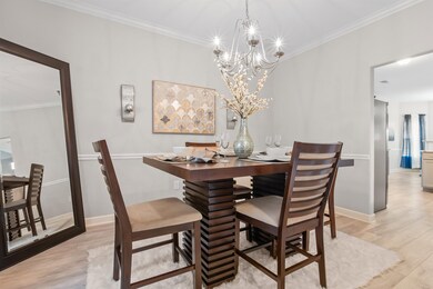 Dining space with light wood-type flooring, orname