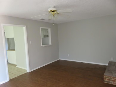 Unfurnished room featuring ceiling fan, dark tile flooring, and a textured ceiling