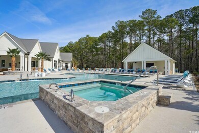 View of pool featuring a patio area and a hot tub