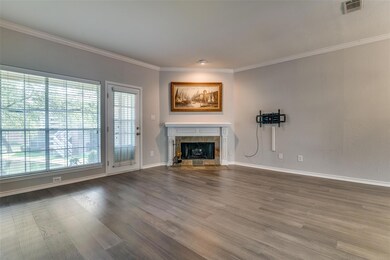 Living room featuring a fireplace, wood flooring, 