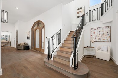 Foyer featuring wood finished floors, stairway, a