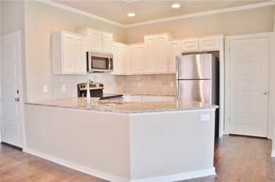 Kitchen - Granite, hardwood floors, white cabinets, crown molding, 2 lazy susans and recessed lighting.  Door is stackable washer/dyer connections. *pictures are not of actual home but similar colors may vary  **refrigerator is not included in list p