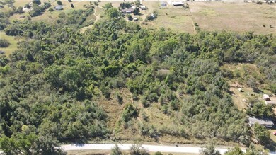 Lot starts to the left of abandoned house